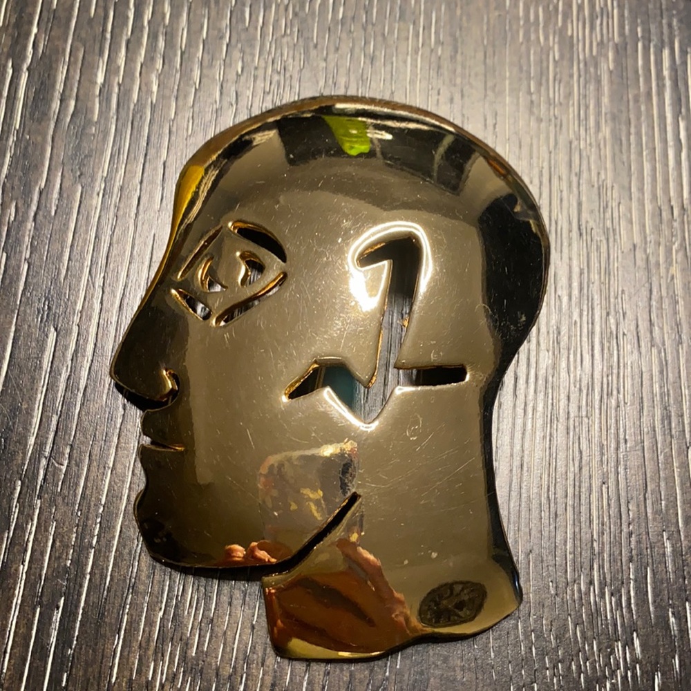 Vintage gold face brooch by Ultra